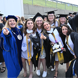 SNHU President Lisa Marsh Ryerson with a group of graduating students.