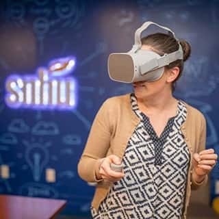Woman playing a video game using a VR headset