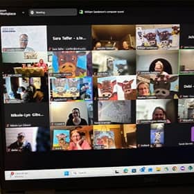 A computer screen with virtual paint night participants holding their art in a video call.