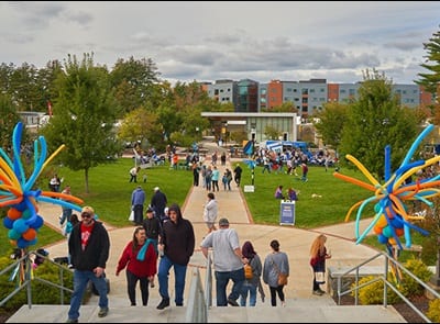 People gathered on Southern New Hampshire University's green space during the 2023 Homecoming Street Fair