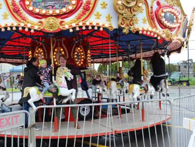 Two women on a carousel at SNHU's homecoming weekend.