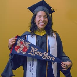 Jennifer Guayllazaca '25G, Master of Science (MS) in Management with a concentration in Construction Management graduate from SNHU, holding a New York state pennant.