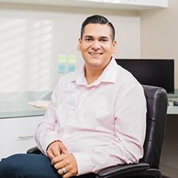 Juan Munoz '22 '24MBA, bachelor's in general studies and Master of Business Administration (MBA) from SNHU, at his desk.