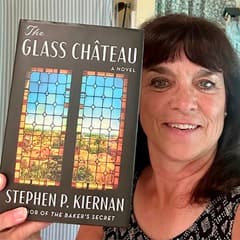 Karin L. Heffernan, campus faculty librarian and associate professor at SNHU, holding a book