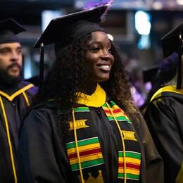 Kendreka Griffin, a 2024 SNHU graduate who earned her bachelor's in business administration, sitting in the crowd at her commencement ceremony.