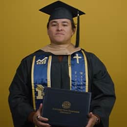 Kevin Bucardo '25MBA, MBA with a concentration in Finance graduate from SNHU, in a cap and gown at his graduation ceremony.
