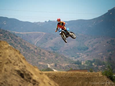 Marissa Markelon on a dirt bike high in the air after going off a jump.