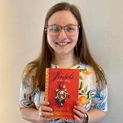 Maurah Matyas, an academic advisor at SNHU, holding a book