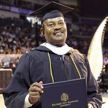 Father Michael Glenn attending SNHU spring Commencement 2023