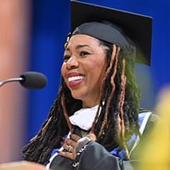 Noelle Jones Ranzy, a 2026 SNHU graduate with a bachelor's in psychology, speaking at her commencement ceremony.