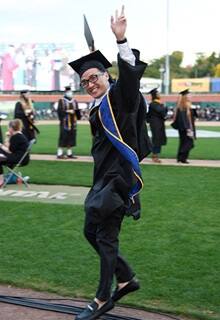 A snhu graduate celebrating at commencement 
