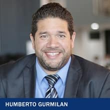 Humberto Gurmilan in a suit with text: Humberto Gurmilan