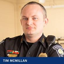 Tim McMillian in a police uniform with text: Tim McMillian
