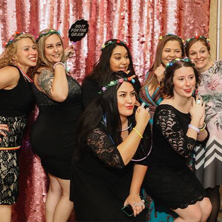 Military spouse attendees posing and holding signs at the Operation Homefront event