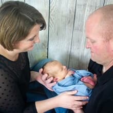 Tevera Holcomb Hesslink and her husband, John, holding newborn son Joel.