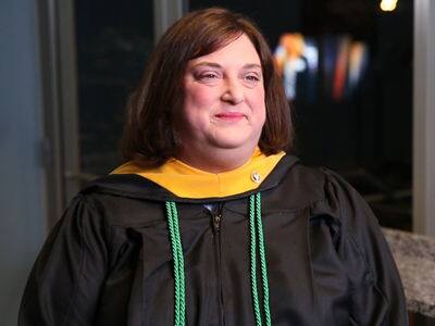 Christen Ganley, who earned her online master's in higher education administration in 2019, wearing her graduation gown.