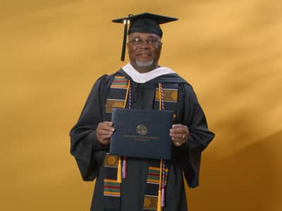 Dennis Peacock, a 2024 graduate who earned his bachelor's in graphic design and media arts.