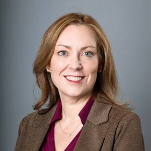 Dr. Jennifer Teague, executive director of SNHU's online business programs, wearing a brown blazer and maroon blouse.