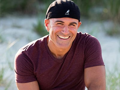 Josh Garrin, associate dean of online psychology programs at SNHU, wearing a maroon T-shirt and black hat.
