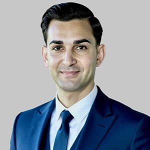 Dr. Leonardo Lawrence, the associate dean of artificial intelligence at SNHU, wearing a blue suit and tie with a white pocket square.
