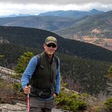 Ben Cole standing on a mountain