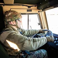 SNHU graduate and U.S. Army Reserve Observer Trainer/Coach Rob Thomas driving a truck.