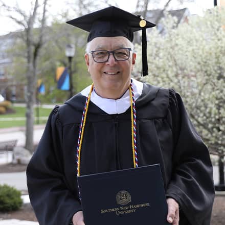 Father Robert Heckinger attending SNHU spring Commencement 2023