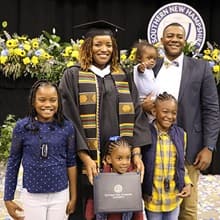 Shaquita Callier with her husband and 4 children after graduation 