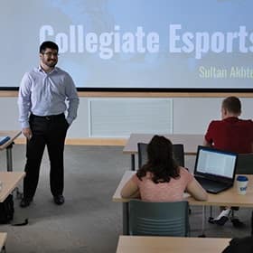 Sultan Akhter speaking in a lecture hall in front of students