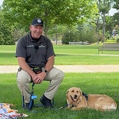 Sunny, SNHU's comfort dog, and her handler Steve Jankowski, senior public safety supervisor at SNHU.