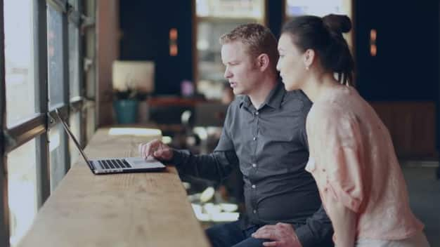 Two students looking at a computer