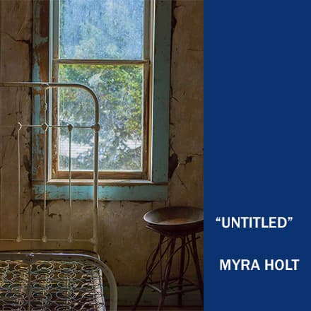 An old bedroom with a metal bed frame in front of a window with a small stool next to it with the text "Untitled" Myra Holt