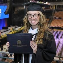 Victoria Meuse dressed in a graduation cap and gown