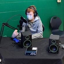 A child interacting with audiovisual equipment in the new green screen room, a studio attached to the STEAM lab at Webster Elementary School.