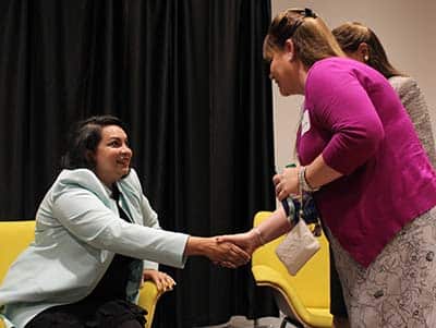 A panelist greeting an audience member at the Women in Business panel discussion 