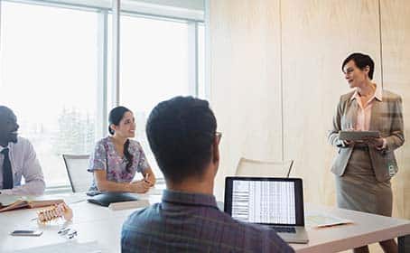 A group of business men and women at a meeting