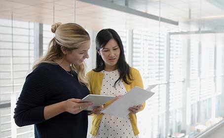 Two business women reviewing a report