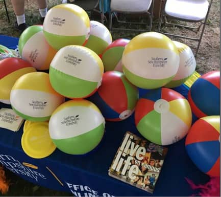 Beach balls on a table that SNHU had set up at the Portsmouth Pride event in New Hampshire