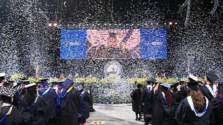 Confetti falling over graduates at the SNHU 2025 Spring Commencement 