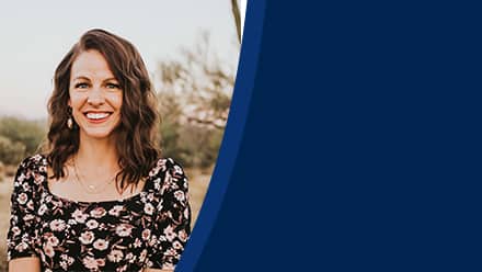 Dr. Ashley Dellosa, an associate business dean at SNHU, wearing a black top with light flowers on it.