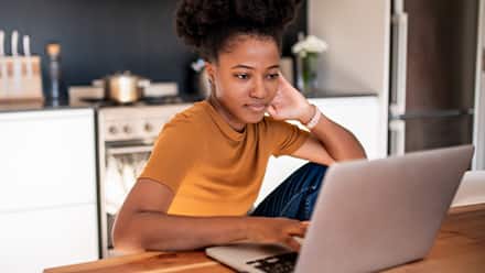 A person researching the difference between certificates and degrees on the laptop.