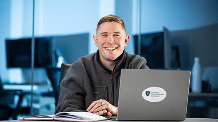 Rob Thomas '24, SNHU graduate with a bachelor's in general studies, studying on his laptop.