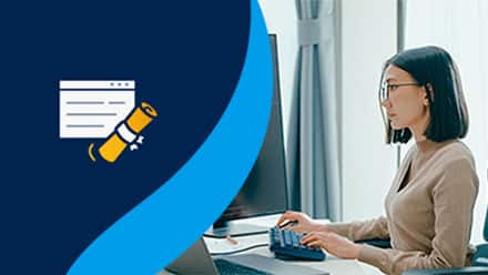 An icon of a diploma to the left of a cybersecurity professional who is typing on a keyboard in front of a large monitor of code.