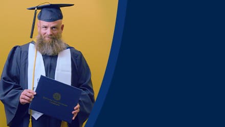 Gerald Pruitt '25, operations management with a concentration in project management from SNHU, holding a diploma cover.