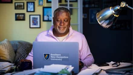 Corey Dantzler, an SNHU graduate working on his masters degree from his home desk.