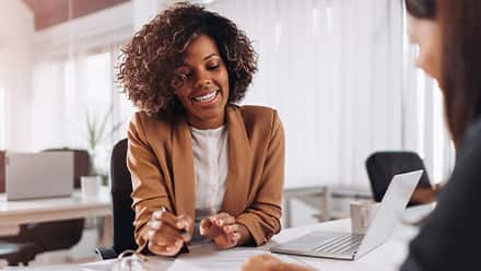 A woman who became a certified financial planner working with a client.