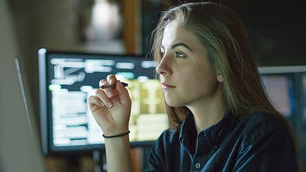 A cybersecurity analyst working on her laptop