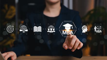 A person selecting an MBA icon on a virtual display with education and career symbols.
