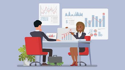 An illustration of a financial advisor sitting at a desk, showing her client several charts.