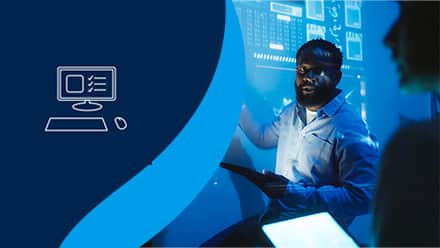 An icon of a desktop computer alongside a tech professional presenting data projected in blue.